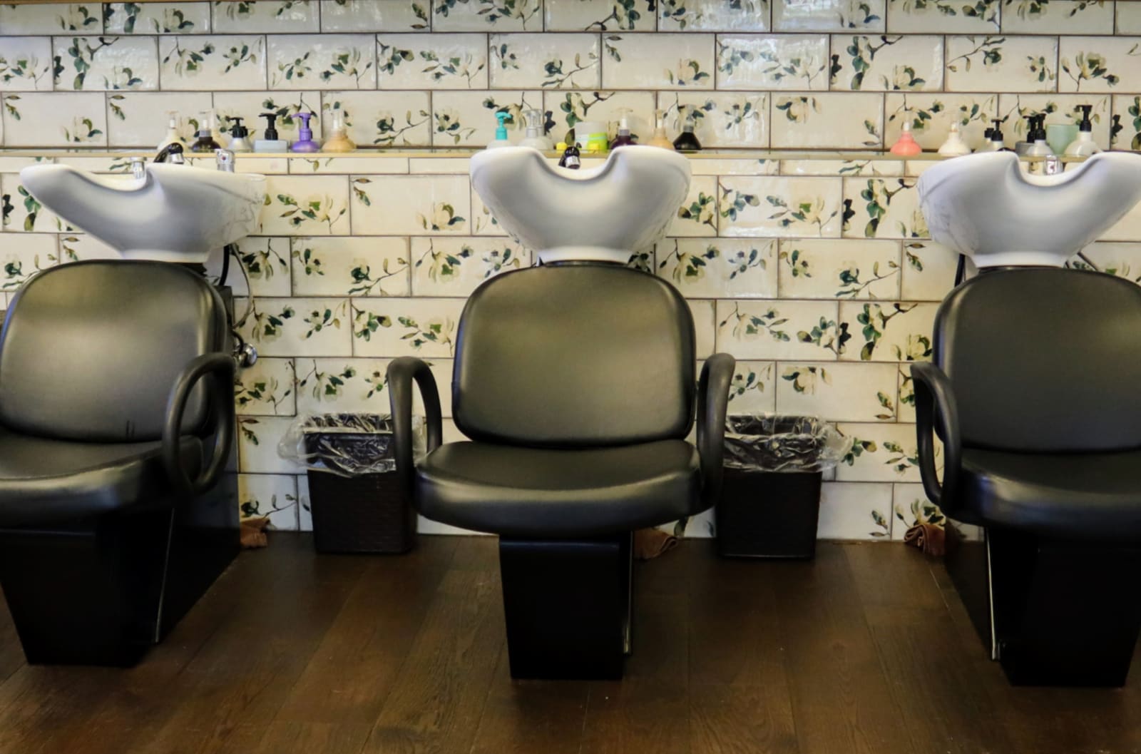 Shampoo and backwash chair at Salon Marie set against botanical patterned tile